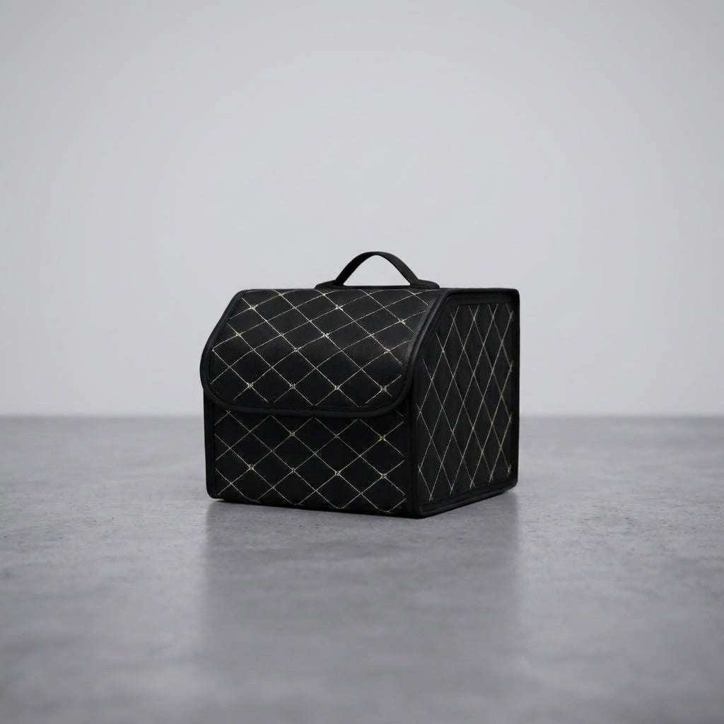 A single Matrikar trunk organizer in Black with White Stitching, small size, on a studio floor