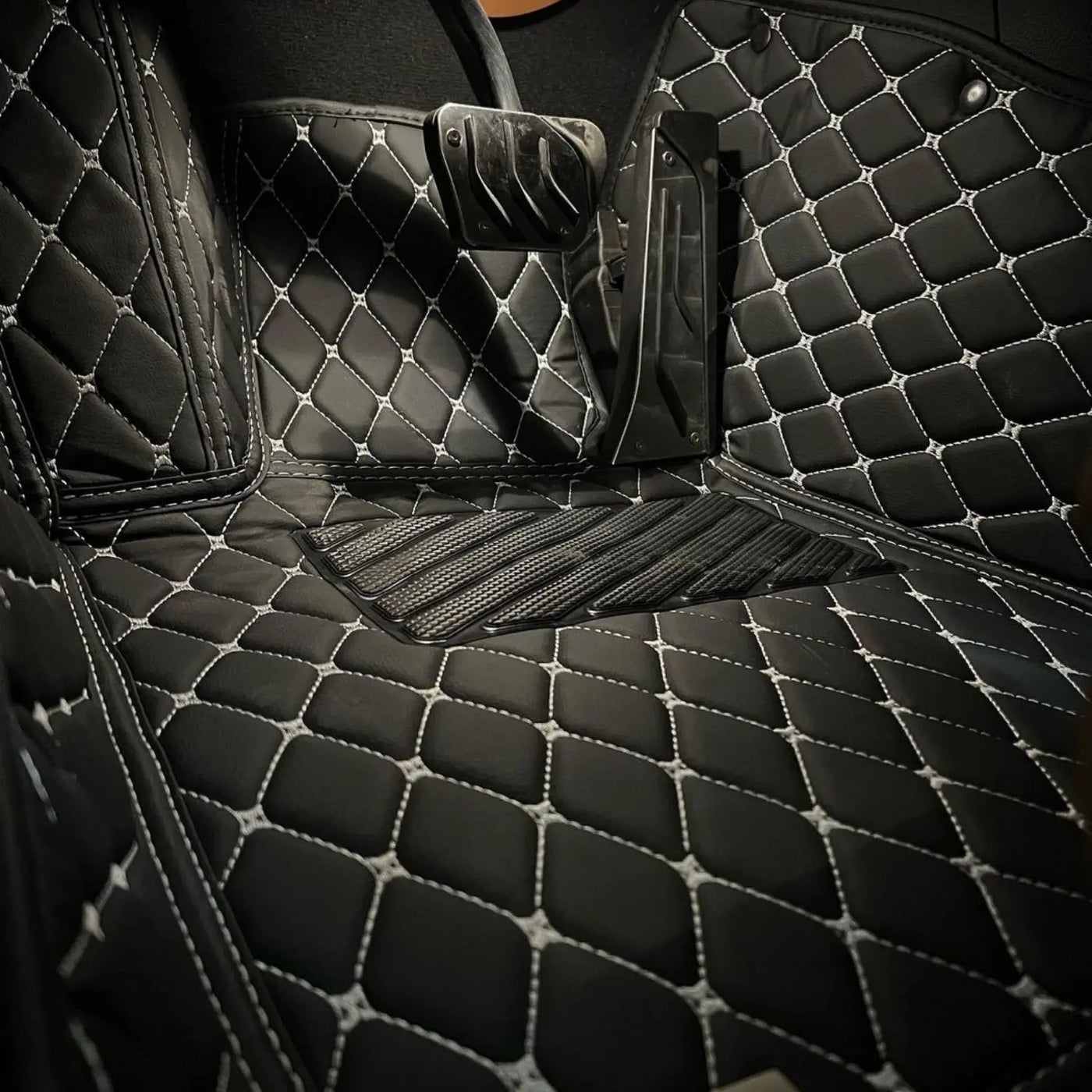 Matrikar leather mats in a luxury car footwell