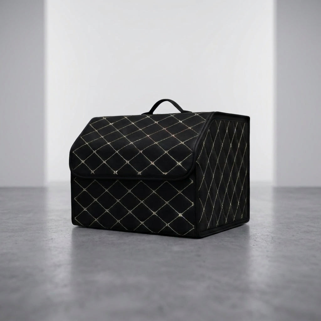 A single Matrikar trunk organizer in Black with White Stitching, medium size, on a studio floor