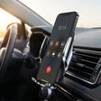 Matrikar wireless car charger mounted on a car air vent holding a phone during a call
