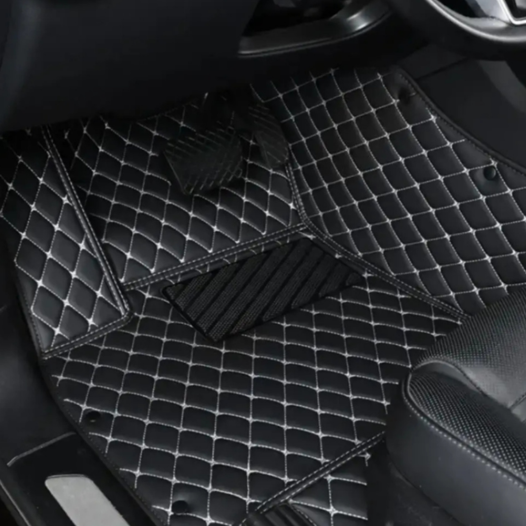 Matrikar Diamond Series custom fit car mat in Black with white stitching, installed in a driver footwell